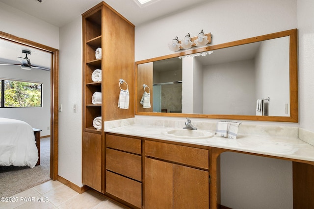 bathroom with vanity, tile patterned floors, a ceiling fan, a shower with shower door, and ensuite bath
