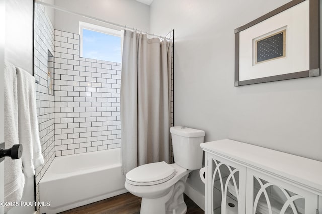 full bath with shower / tub combo, toilet, and wood finished floors