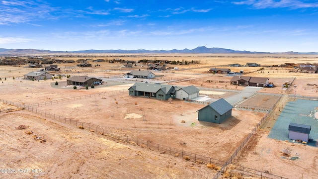 birds eye view of property featuring a rural view, a desert view, and a mountain view