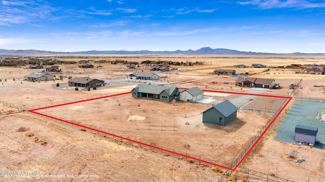 bird's eye view with a rural view, a mountain view, and view of desert