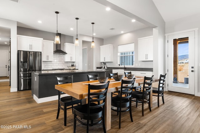 dining space with dark wood-style flooring, visible vents, and recessed lighting