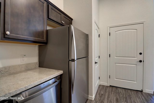 8346 Florentine Rd, Prescott Valley, AZ 86314 - kitchen with appliances with stainless steel finishes, dark brown cabinetry, light countertops, and dark wood finished floors