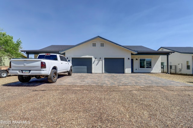 8346 Florentine Rd, Prescott Valley, AZ 86314 - view of front of house featuring a garage, decorative driveway, and stucco siding