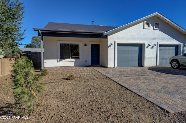 8346 Florentine Rd, Prescott Valley, AZ 86314 - view of front of house featuring an attached garage, decorative driveway, and stucco siding