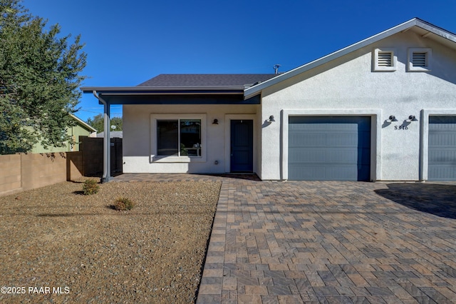 8346 Florentine Rd, Prescott Valley, AZ 86314 - view of front of house with stucco siding, a garage, and decorative driveway