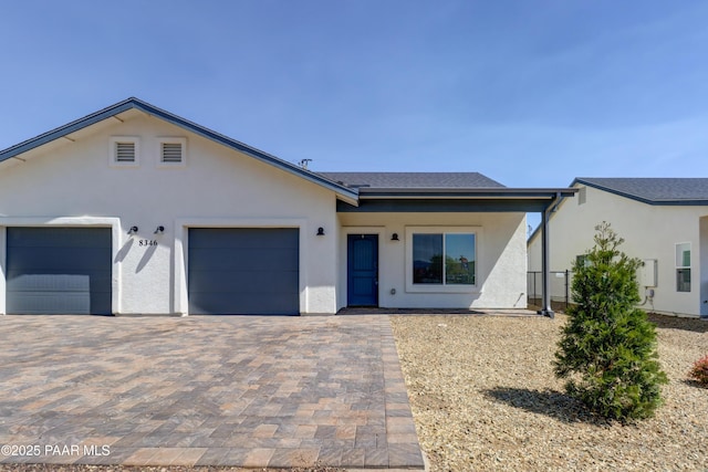 8346 Florentine Rd, Prescott Valley, AZ 86314 - view of front facade with stucco siding, an attached garage, decorative driveway, and a shingled roof
