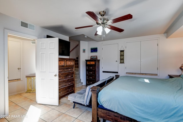 bedroom featuring light tile patterned floors, visible vents, and a ceiling fan