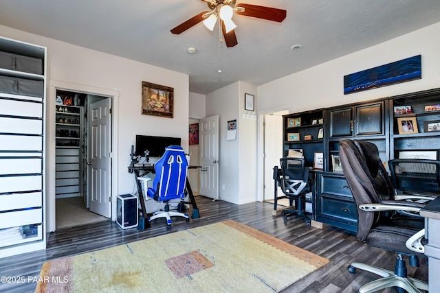 office area featuring baseboards, dark wood finished floors, and a ceiling fan