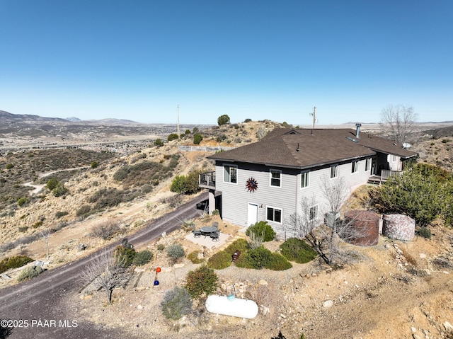 back of property featuring a mountain view