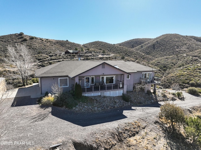 single story home featuring driveway and a mountain view