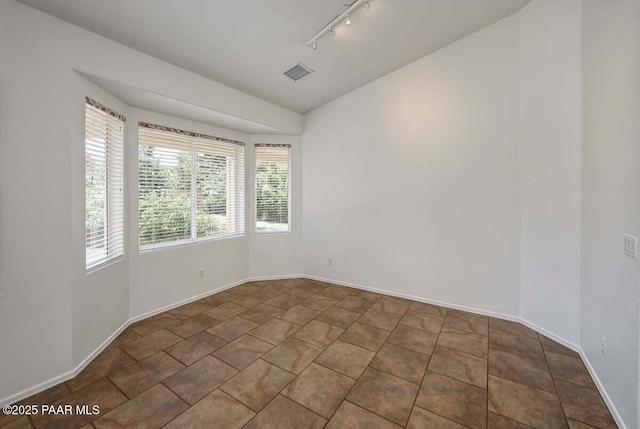 7461 N Windy Walk Way, Prescott Valley, AZ 86315 - unfurnished room with rail lighting and lofted ceiling