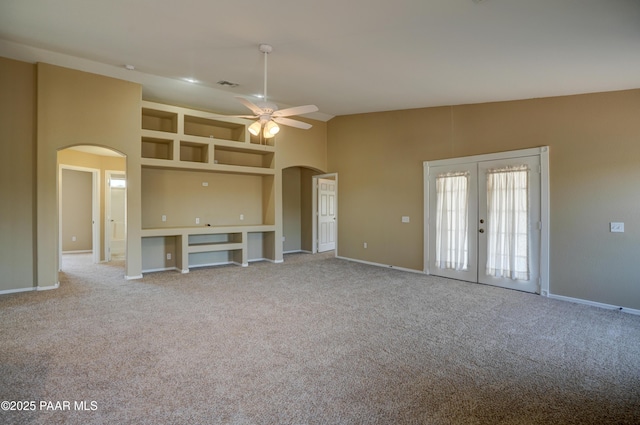 20100 E Mesa Verde Rd, Mayer, AZ 86333 - unfurnished living room featuring arched walkways, ceiling fan, carpet floors, french doors, and lofted ceiling