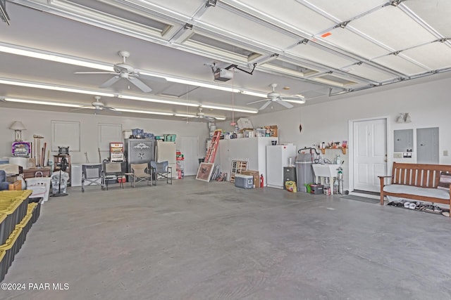 garage with ceiling fan, electric panel, sink, and a garage door opener