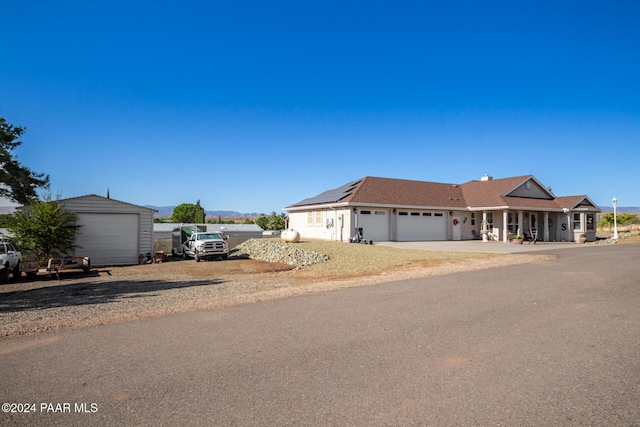 ranch-style home featuring solar panels