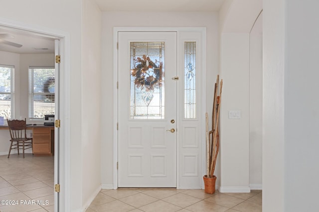 entrance foyer featuring light tile patterned flooring and a wealth of natural light