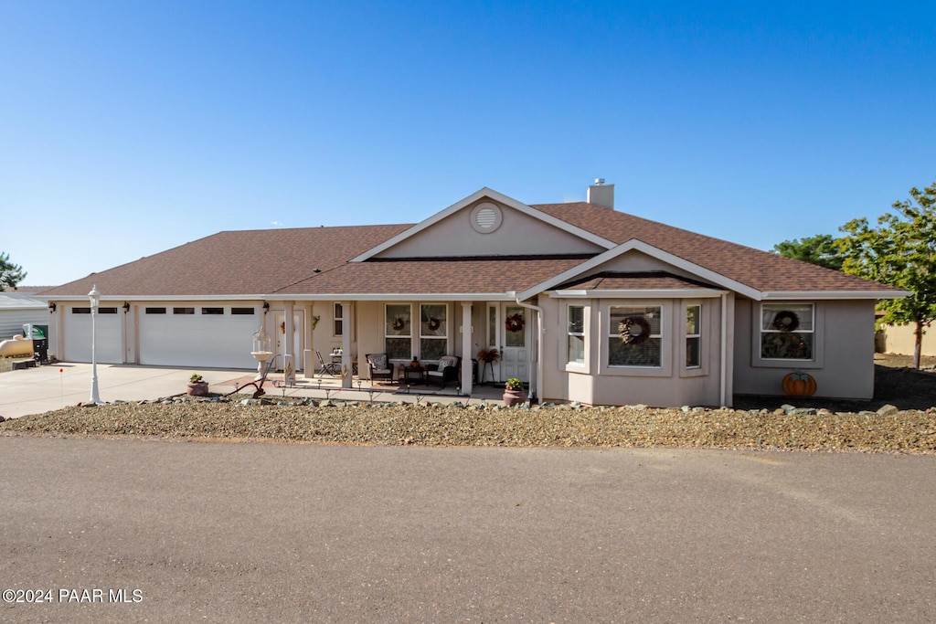 17475 E Jackrabbit Rd, Mayer, AZ 86333 - ranch-style home featuring a garage, covered porch, driveway, a chimney, and a shingled roof