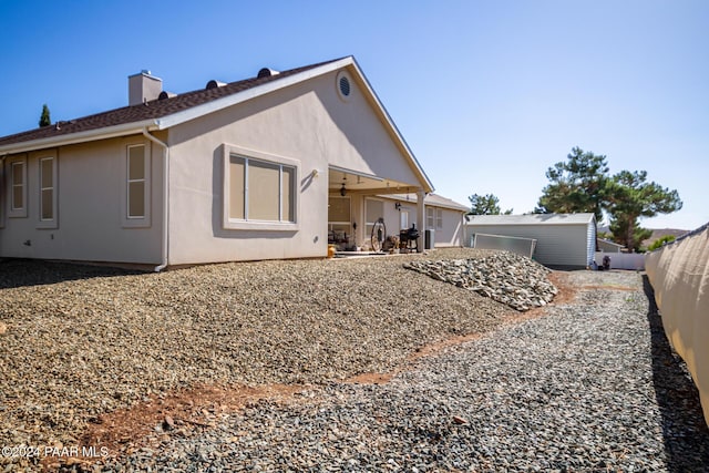 back of house with ceiling fan