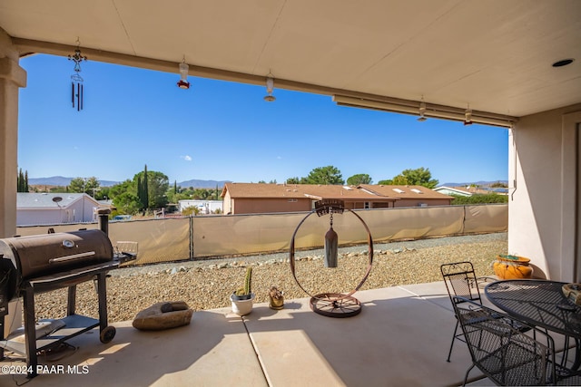 view of patio with grilling area and a mountain view