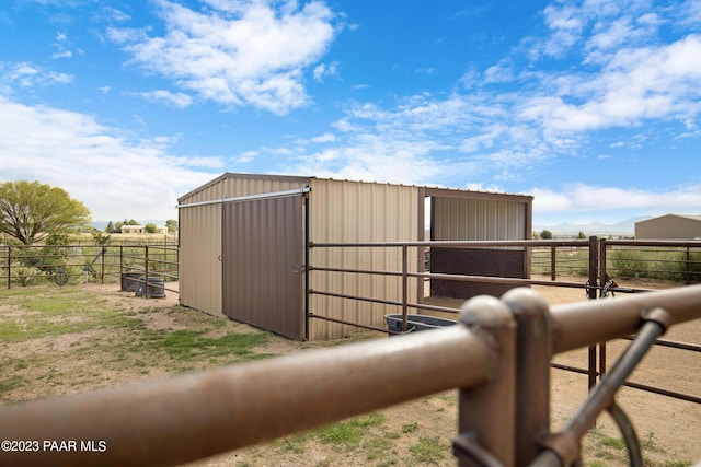 view of stable featuring a rural view