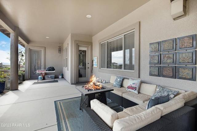 view of patio featuring an outdoor living space with a fire pit