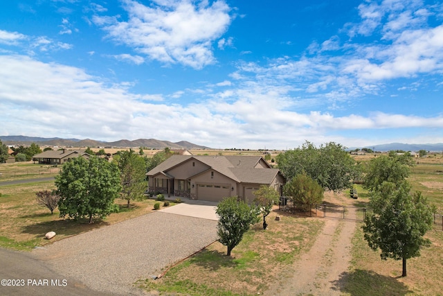 view of front of property featuring a mountain view and a garage