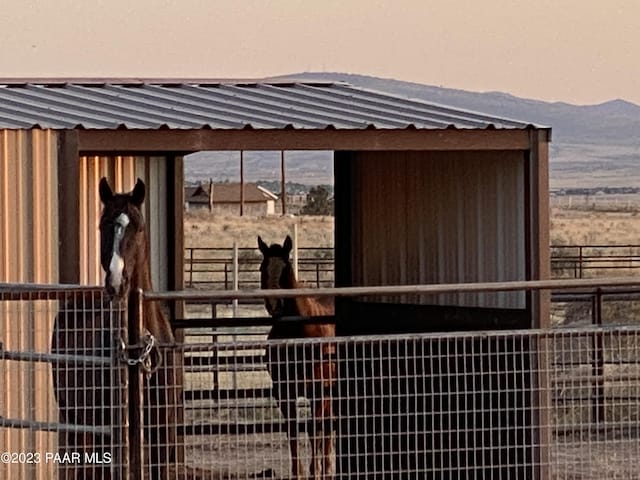 view of stable with a mountain view