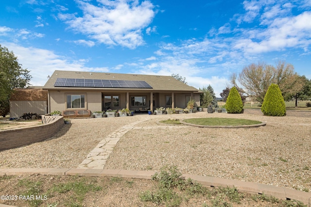 back of house with solar panels