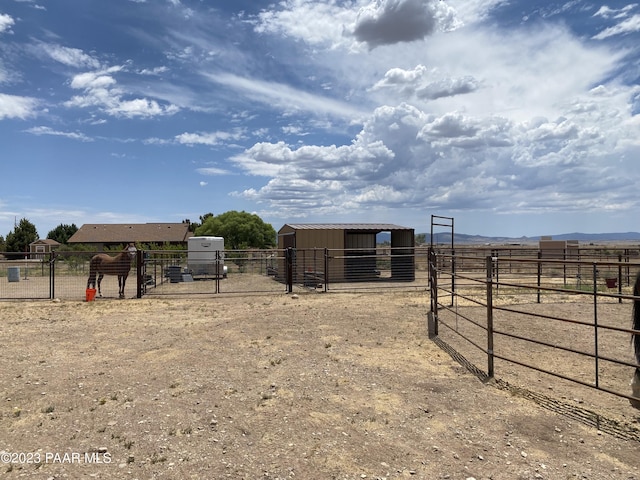 view of yard with a rural view and an outdoor structure