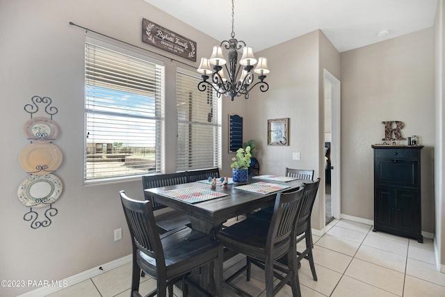 tiled dining room with a chandelier