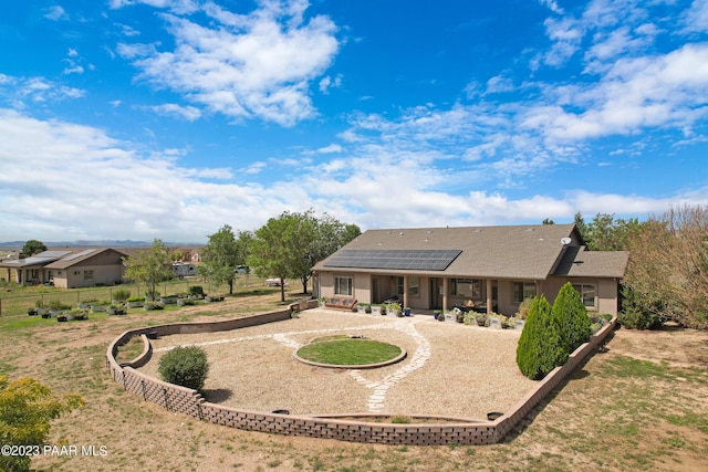 back of property featuring a patio and solar panels