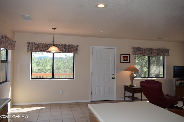 bedroom with light tile patterned floors and a textured ceiling