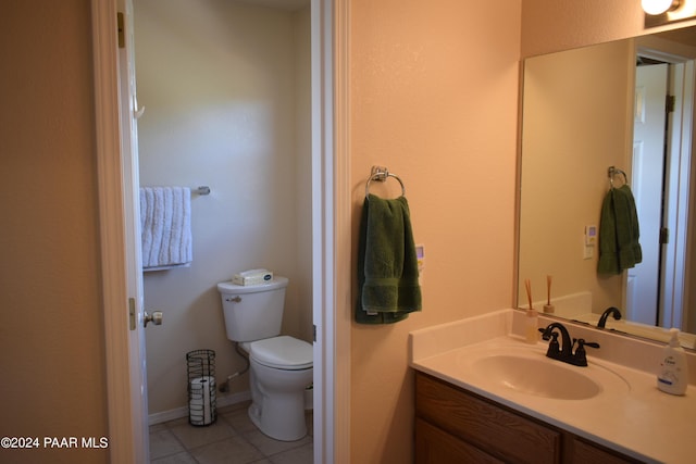 bathroom with tile patterned floors, vanity, and toilet