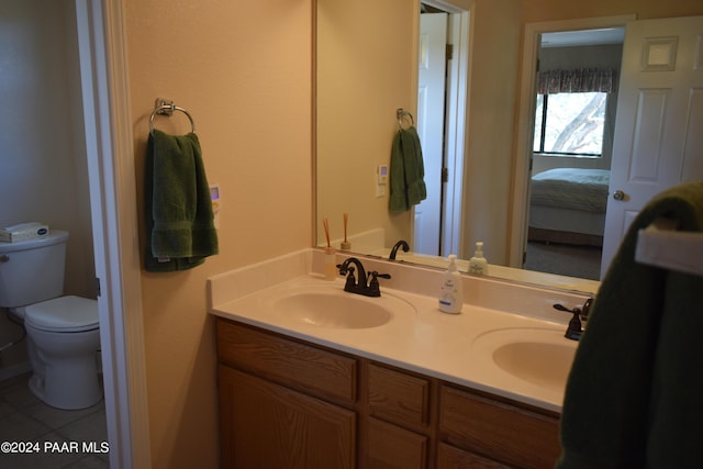 bathroom with tile patterned floors, vanity, and toilet