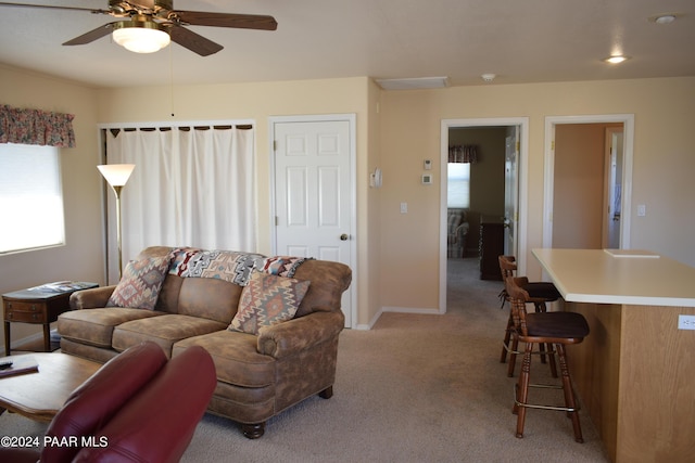 carpeted living room featuring ceiling fan