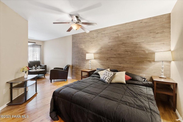 3050 Smokey Rd Unit 20D, Prescott, AZ 86301 - bedroom with an accent wall, wood finished floors, a ceiling fan, and wooden walls
