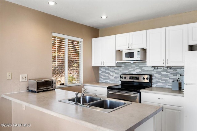 3050 Smokey Rd Unit 20D, Prescott, AZ 86301 - kitchen with white appliances, decorative backsplash, white cabinetry, light countertops, and a peninsula