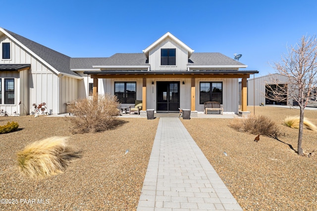 modern inspired farmhouse with board and batten siding and roof with shingles