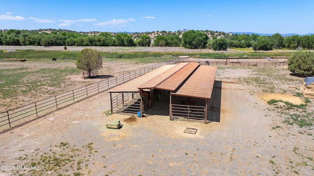 exterior space with an outbuilding, a rural view, and an exterior structure