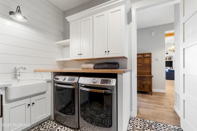 laundry room featuring a sink, cabinet space, and washer and clothes dryer