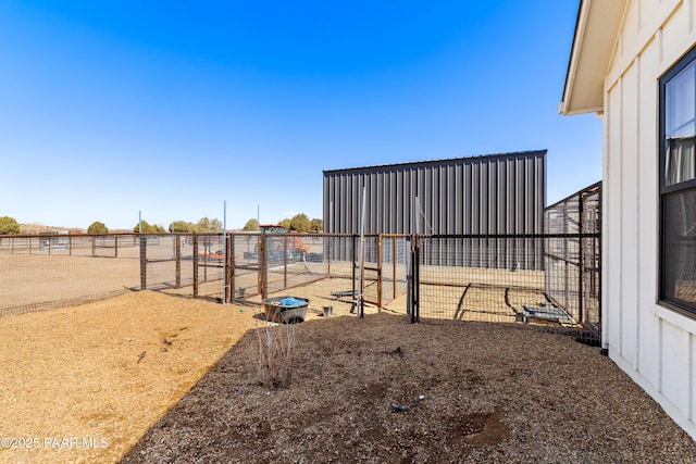 view of yard with an outbuilding and fence