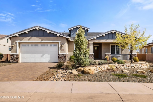 848 Royal Tulips St, Prescott, AZ 86301 - craftsman-style house featuring decorative driveway, stone siding, a garage, covered porch, and stucco siding