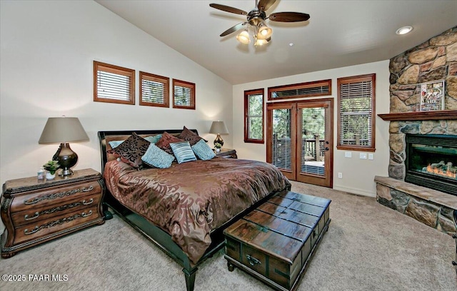 2140 Lone Oak Way, Prescott, AZ 86305 - carpeted bedroom featuring access to exterior, vaulted ceiling, a stone fireplace, and a ceiling fan