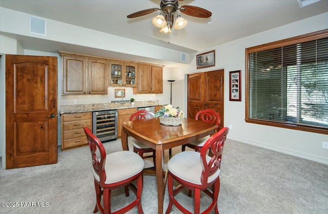 2140 Lone Oak Way, Prescott, AZ 86305 - dining area with wine cooler, light carpet, ceiling fan, and bar area