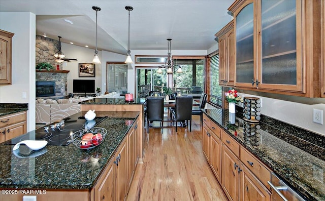 2140 Lone Oak Way, Prescott, AZ 86305 - kitchen with light wood-style flooring, open floor plan, black electric cooktop, a ceiling fan, and a center island