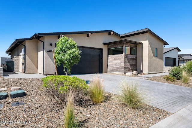 5692 E Cannon Pl, Prescott Valley, AZ 86314 - view of front of home with stucco siding, an attached garage, and concrete driveway