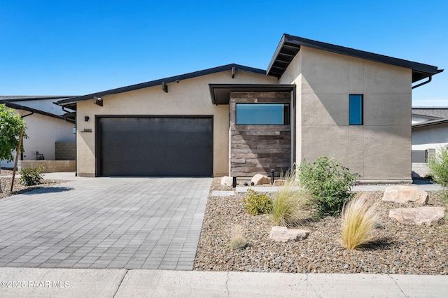 5692 E Cannon Pl, Prescott Valley, AZ 86314 - view of front of home with stucco siding, a garage, and decorative driveway