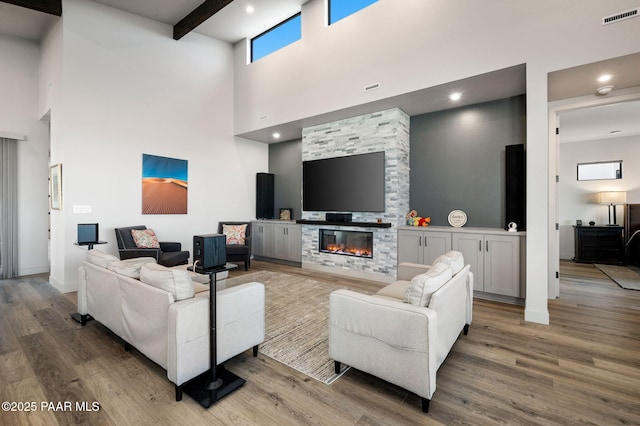 5692 E Cannon Pl, Prescott Valley, AZ 86314 - living area with a high ceiling, wood finished floors, a stone fireplace, recessed lighting, and beam ceiling
