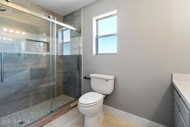 bathroom featuring toilet, a shower with door, vanity, and tile patterned floors