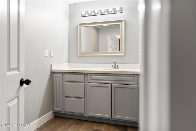 bathroom with hardwood / wood-style floors and vanity