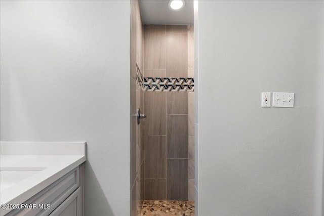 bathroom featuring a shower and vanity